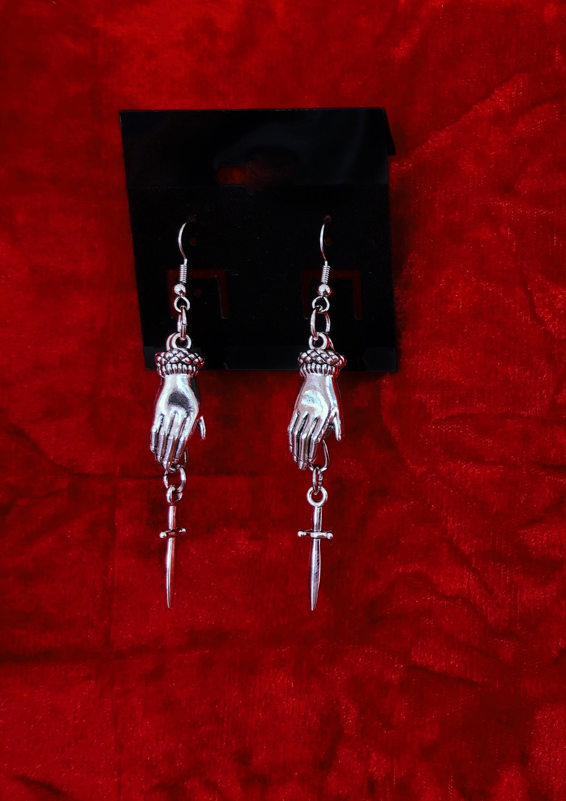Hand and dagger earrings