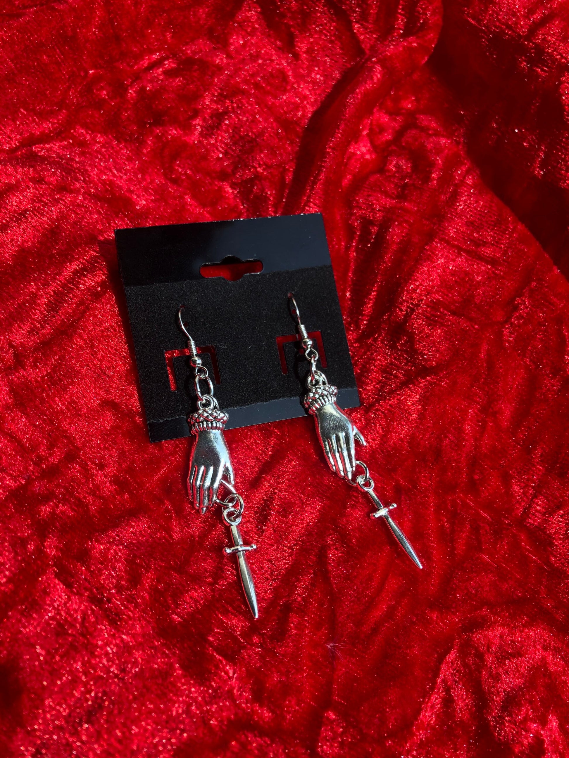 Hand and dagger earrings